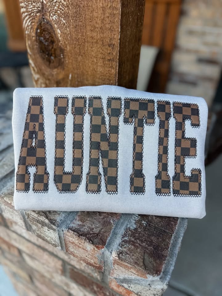 Brown checkered AUNTIE appliqué on a Gildan crewneck, front view