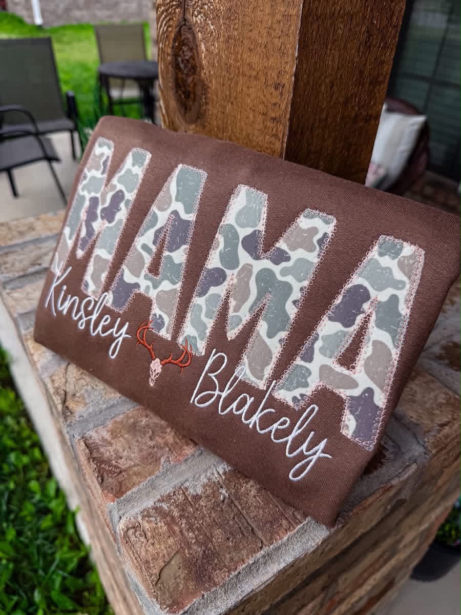 Camo Title with deer and two embroidered names, angled view